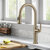 KRAUS Sellette™ Traditional Industrial Pull-Down Single Handle Kitchen Faucet, Brushed Gold, In Use Illustration